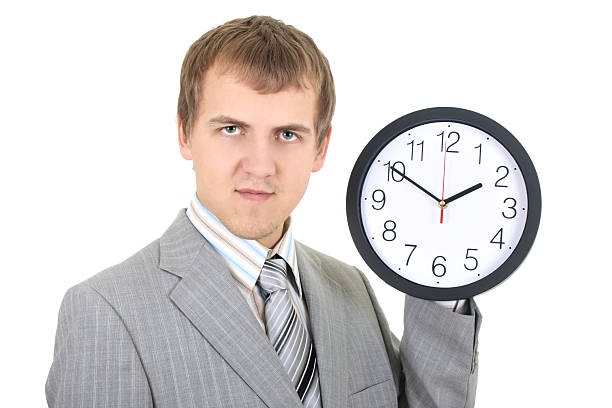istock young businessman holding a clock 119935884