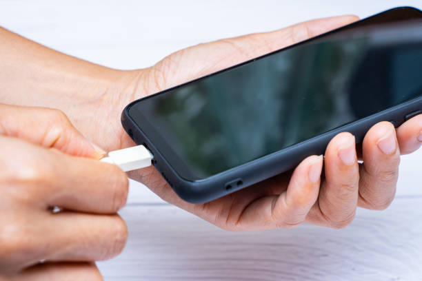 istock charging battery to mobile phone 1199359863