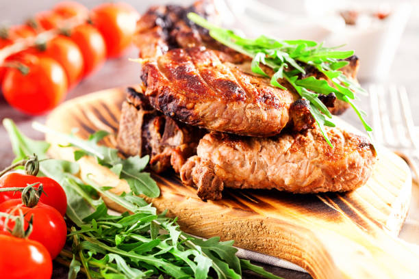 istock Grilled ribeye beef steak with tomatoes, herbs and spices. Selective focus 1199362200