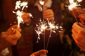 family celebrating christmas holidays, party people holding sparklers