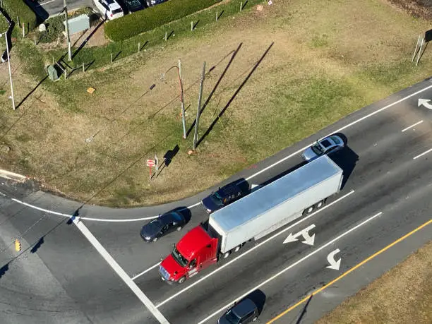 Aerial shot of large truck stopped at an intersection.