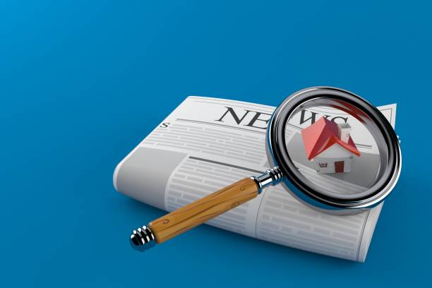 istock Newspaper with house and magnifying glass 1199367118