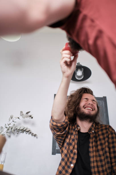 istock Bearded man offering apple to his friend 1199370169
