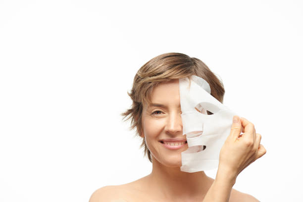 istock Woman peeling mask off her face 1199370600