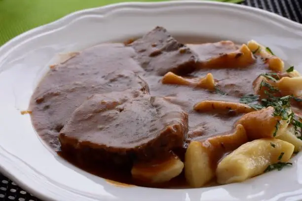 Photo of Croatian traditional cuisine, Pasticada With Gnocchi - Dalmatian Pot Roast or beef/ Croatian dish - Pasticada with gnocchi, beef stew in a sauce