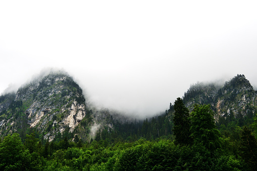 Alpine mountains in the fog on a summer cloudy day. Bovaria, Germany