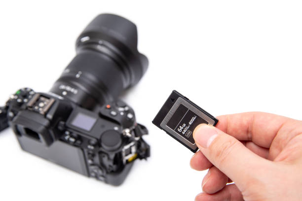 istock Man's hand holding XQD memory card on a white background. 1199372918