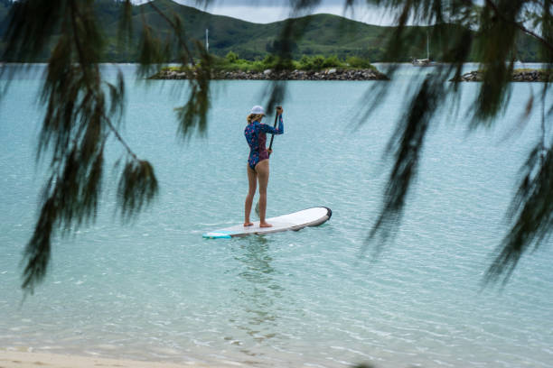 istock Woman on puddle surfboard 1199373950