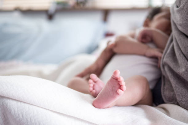 istock Horizontal , mother feed baby with breast milk. 1199375116