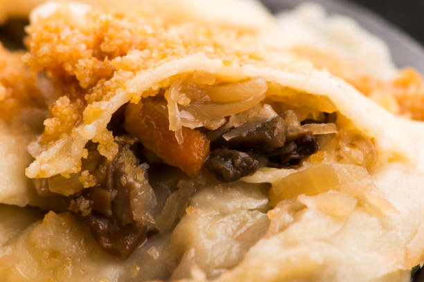 istock Boiled pierogi (Polish dumplings) stuffed with cabbage and mushrooms 1199375673