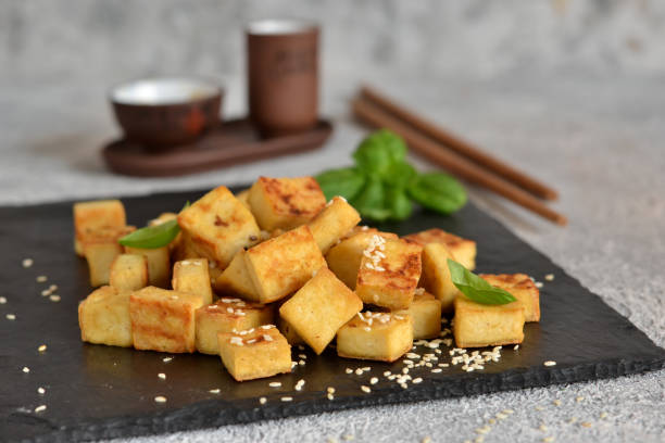 istock Fried tofu with soy sauce on a wooden board. 1199375911