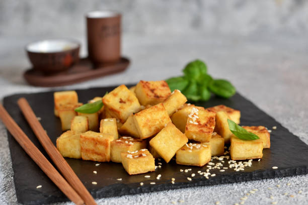istock Fried tofu with soy sauce on a wooden board. 1199375953
