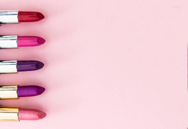 istock Lipsticks various colors against pink background, closeup view 1199377573