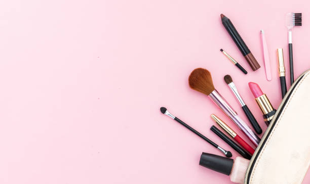istock Make-up cosmetic bag against pink background, copy space 1199377592