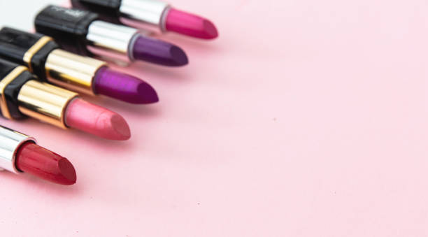 istock Lipsticks various colors against pink background, closeup view 1199377596