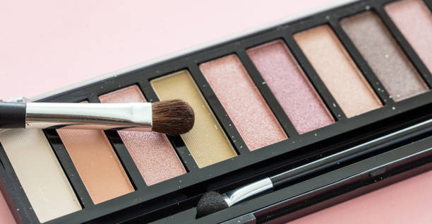 istock Eyeshadow pallete kit against pink background, copy space 1199377630