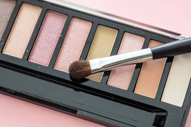 istock Eye shadow pallete kit against pink background, copy space 1199377640