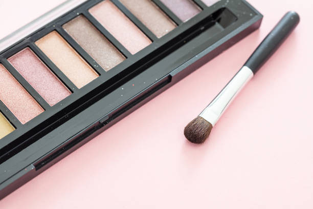 istock Eyeshadow pallete kit against pink background, copy space 1199377656