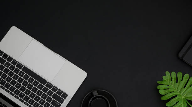 istock Top view of workspace with copy space, laptop keyboard and smartphone on black table 1199381622