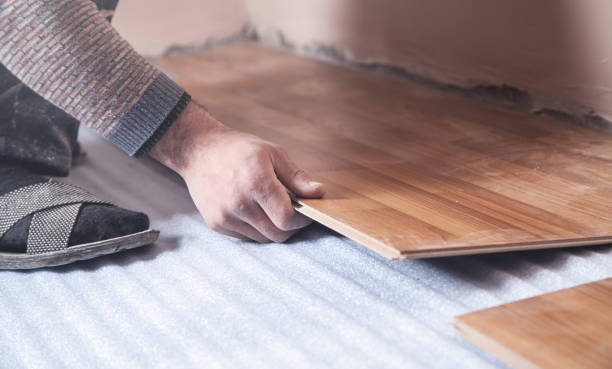 istock Worker installing new laminate wooden floor. 1199381646