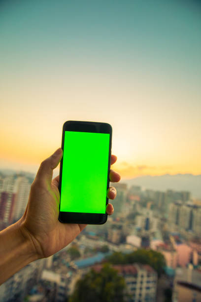 istock Hand holding mobile phone with chroma key screen 1199382931