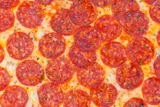 istock Salami pizza with greens close-up top view. 1199385642