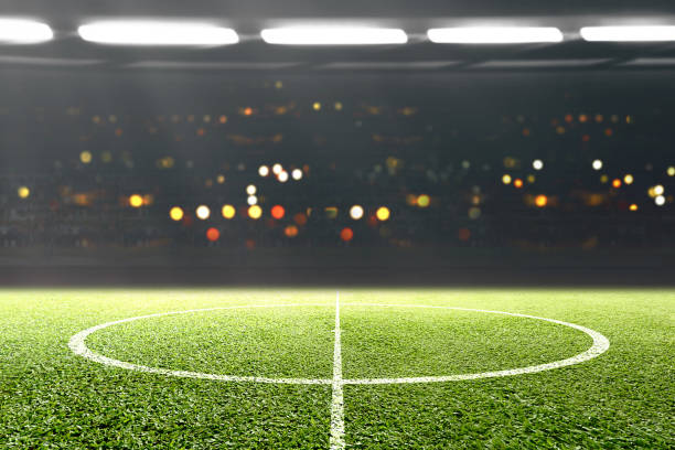 istock Green grass and tribune with blurred lights 1199386960