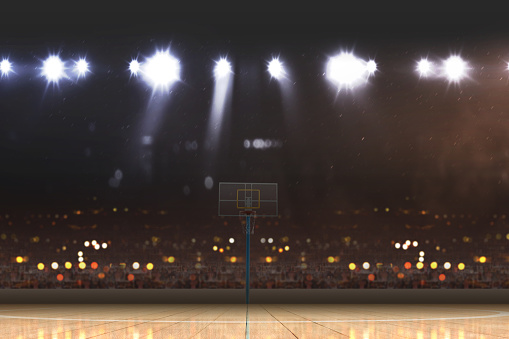 Basketball court with wooden floor and tribune over blurred lights background