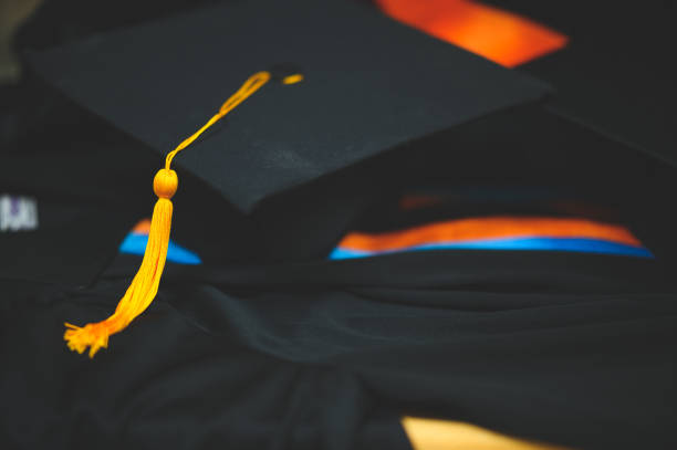 istock Graduation black hat put on a black ruffle dress. 1199390562