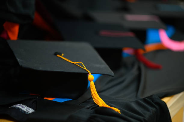 istock Graduation black hat put on a black ruffle dress. 1199390570
