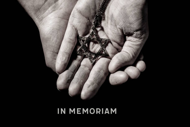 in memoriam, latin phrase equivalent to in memory an old and rusty pendant in the shape of the star of david on the hands of a man and the text in memoriam, a latin phrase equivalent to in memory, as a memory of the dead jewish people holocaust stock pictures, royalty-free photos & images