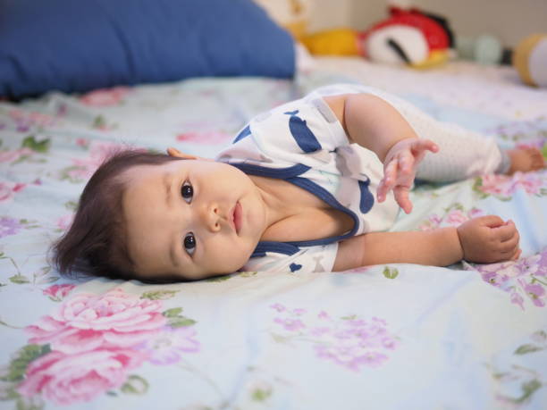 istock Baby lying on the bedand looking at the camera. 1199392108