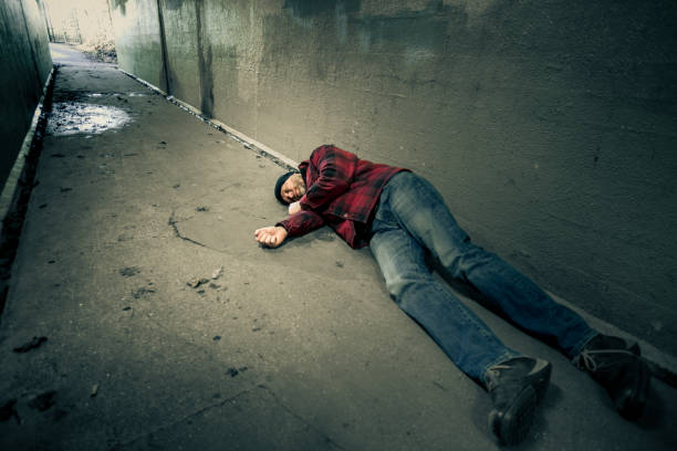 istock Homeless young man sleeping rough in cold subway tunnel 1199392711