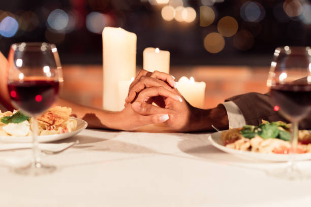 istock Man And Woman Holding Hands On Table In Restaurant, Closeup 1199392973