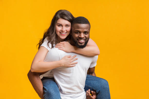 istock Loving black guy carrying his girlfriend on his back 1199393160