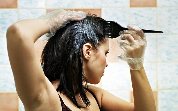 woman dyeing hairs stock photo