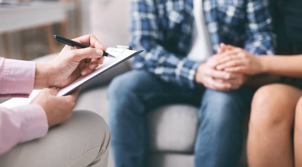 istock Young couple bonding, specialist writing report in notepad 1199394615