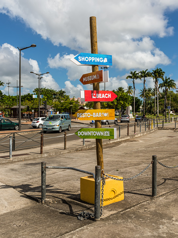 Fort-de-France, Martinique - December 13, 2018: Pillar with pointers (inscriptions) on a colorful background: shopping, Museum, Beach, Resto-bar, Downtown in the city of Fort-de-France, France's Caribbean overseas department of Martinique.