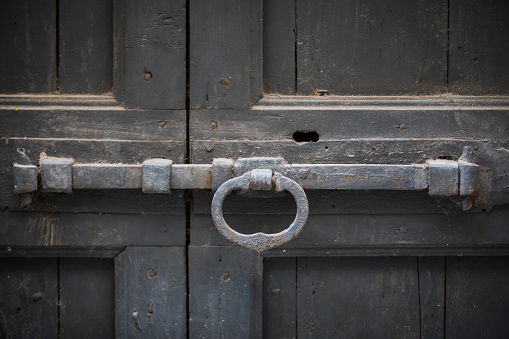 Color image of a vintage lock on a wooden door.