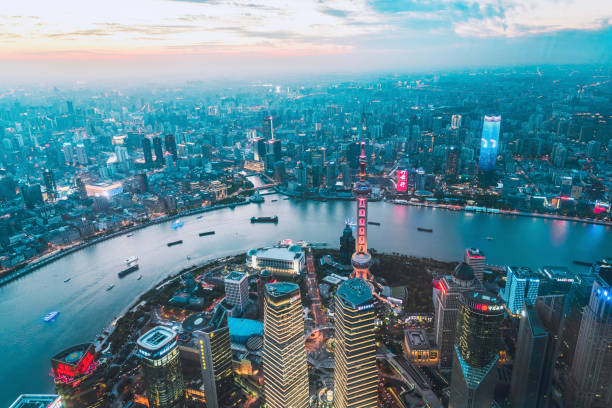 Shanghai China at sunset Aerial view of the Shanghai financial district skyscrapers and the Huangpu river at sunset. shanghai tower stock pictures, royalty-free photos & images