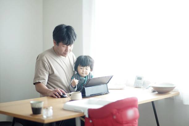 istock Father working at home with son 1199398147