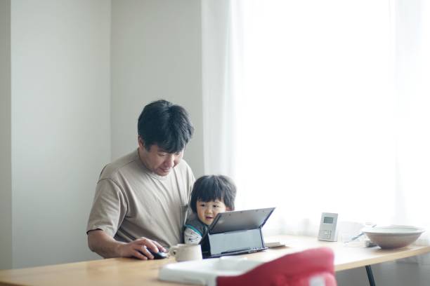 istock Father working at home with son 1199398150