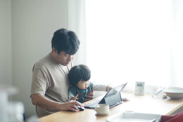istock Father working at home with son 1199398184