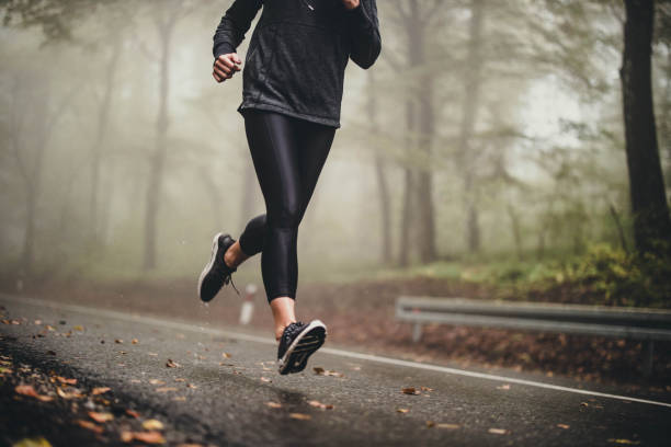 istock Unrecognizable athlete running on misty autumn day in the forest. 1199398316