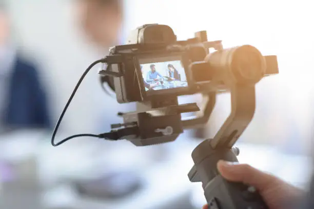 Photo of Professional videomaker shooting a video