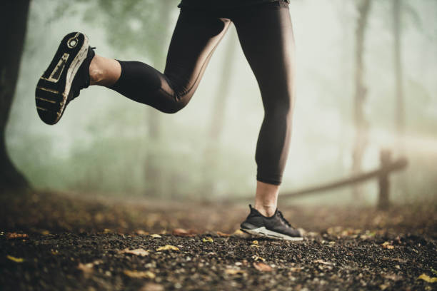 istock Unrecognizable athlete running during bad weather conditions. 1199399496