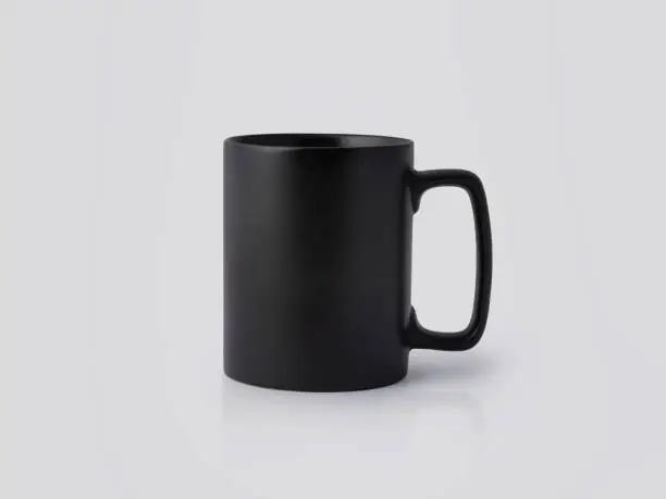 Black Ceramic mug on white background. Blank drink cup for your design