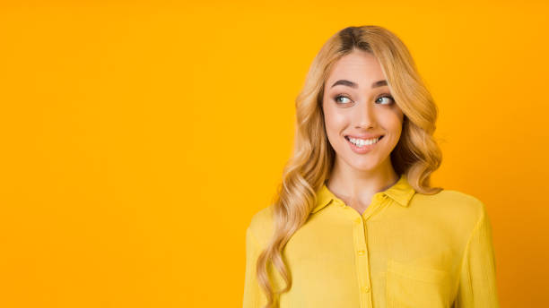 istock Oops. Woman biting lips and looking aside at free space 1199399650