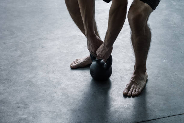 istock Man exercising with a kettlebell at the gym 1199399674