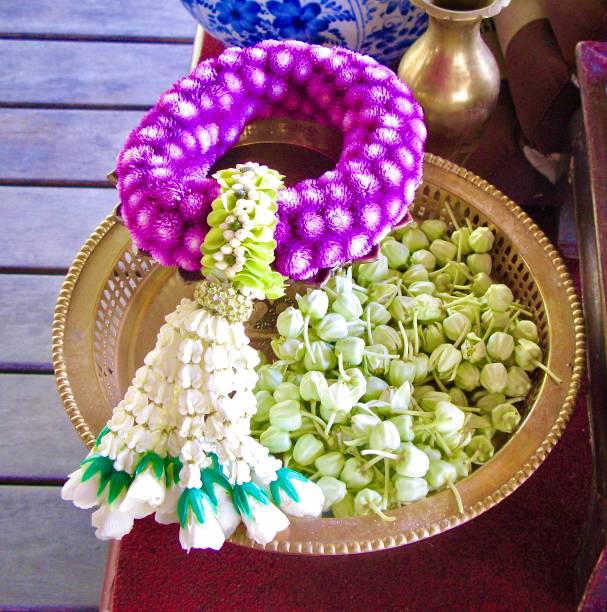 Thai women in Thai traditional dress are decorating flowers.
